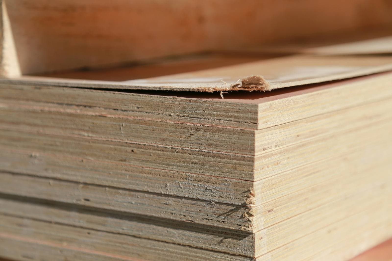 The edge of a stack of plywood sheets, close up