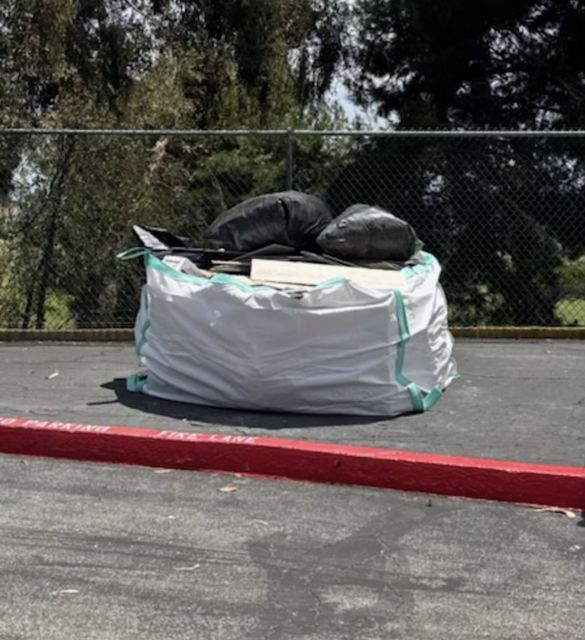 Filled dumpster bag waiting for pickup