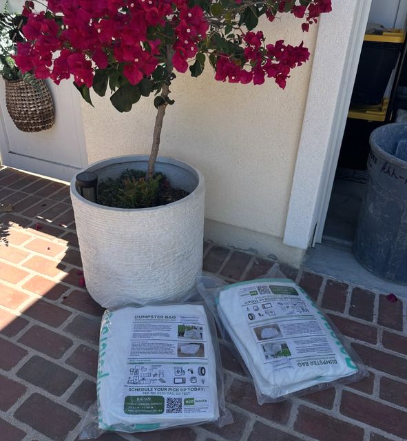 New Eco Waste dumpster bags delivered to a front door